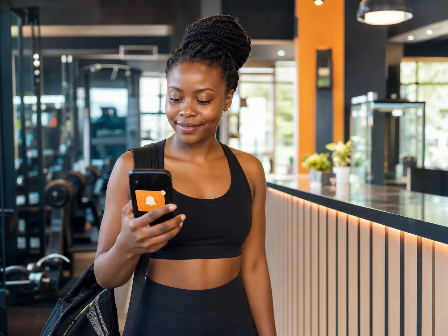 Gym member receiving an automatic renewal reminder on her phone